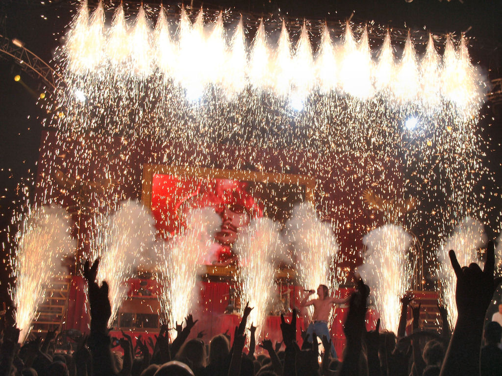 Corporate event with synchronized fireworks display above a skyscraper
