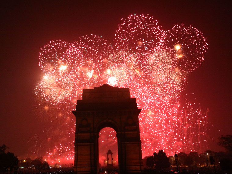 Night cityscape with synchronized corporate fireworks display